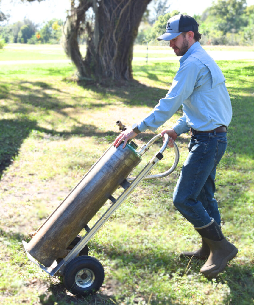 man transporting water conditioning equipment